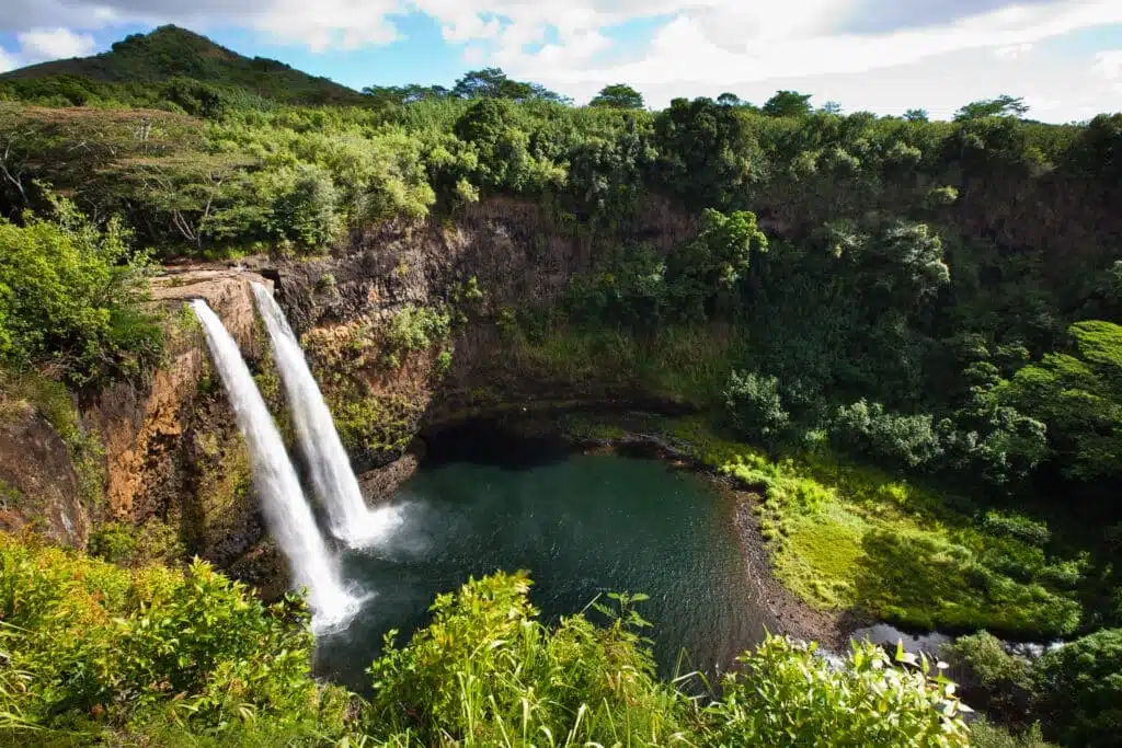Twin falls of Wailua Falls surrouned by lush greenery