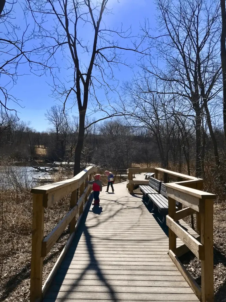 Children walking along the scenic boardwalk on the All Abilities Loop trail at Wehr Nature Center at Whitnall Park.