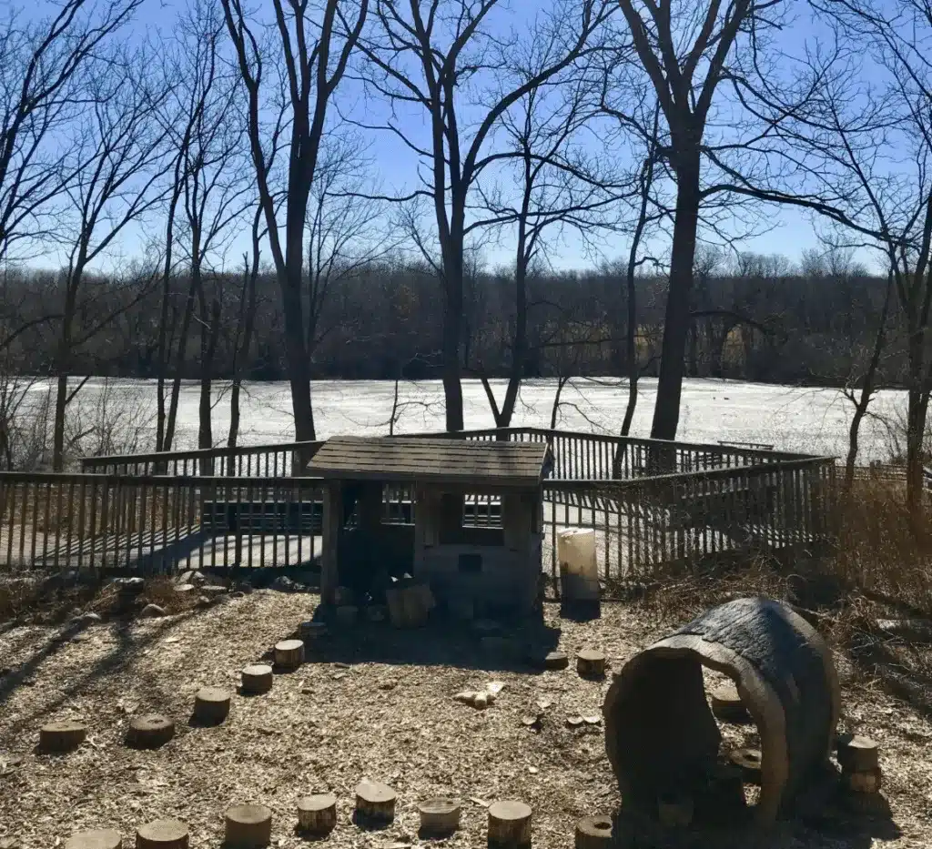Nature play area at Wehr Nature Center overlooking Mallard Lake on a sunny day.