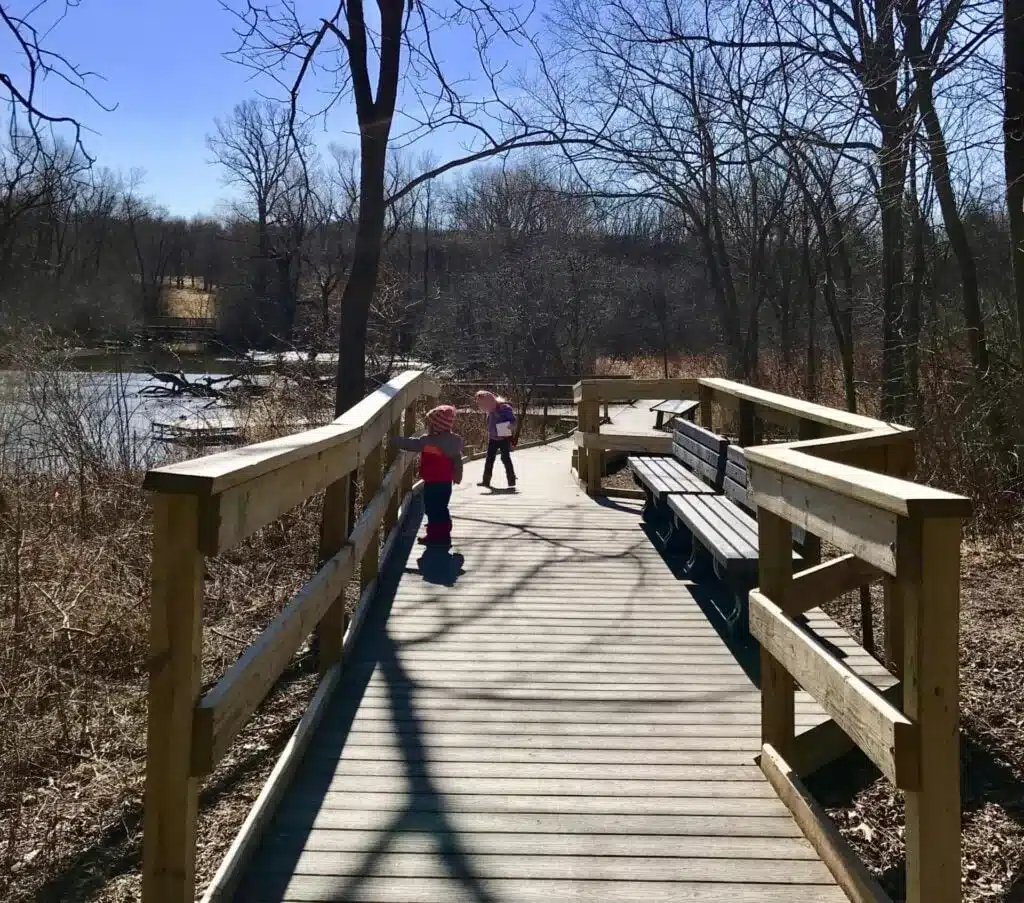 Two kids walking on the Wehr Nature Center board walk