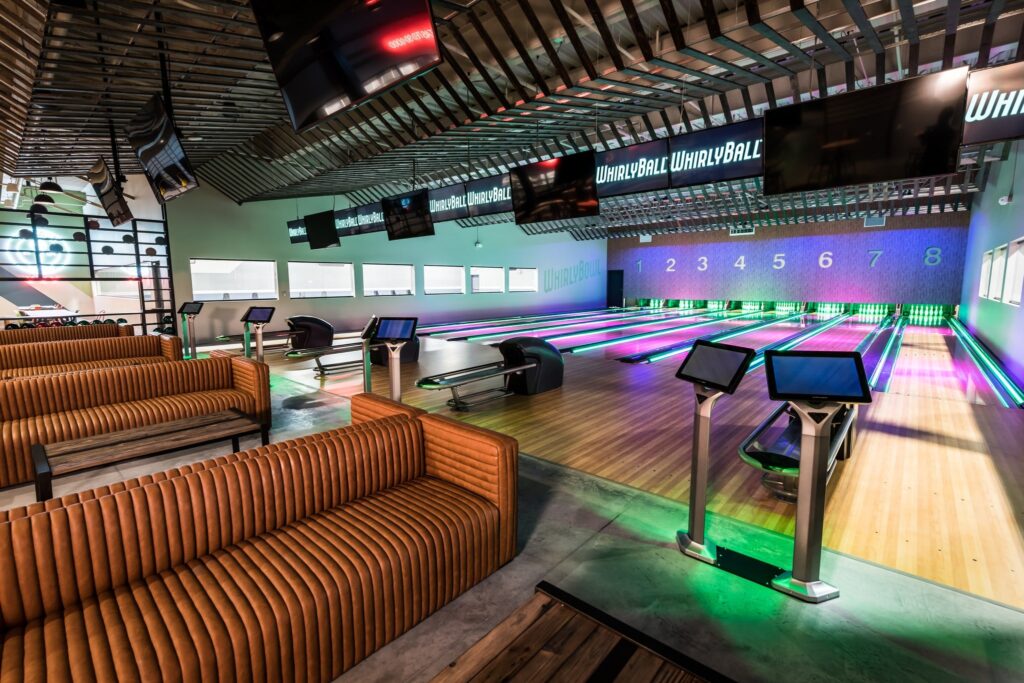 An empty bowling bowl alley with long lounge chairs ready to be occupied at WhirlyBall.