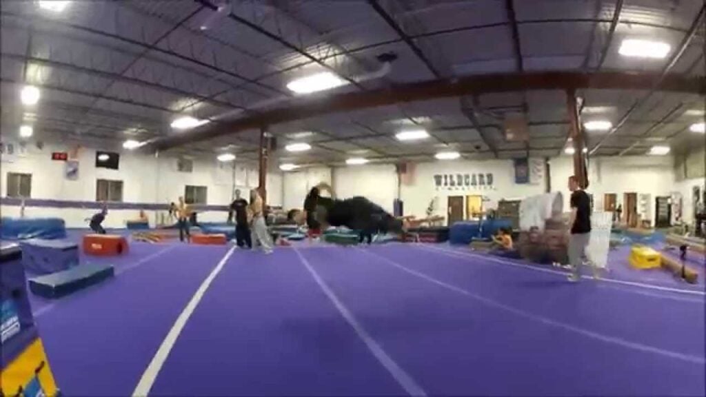 Gymnasts running around and doing skill work at Wildcard Gymnastics.