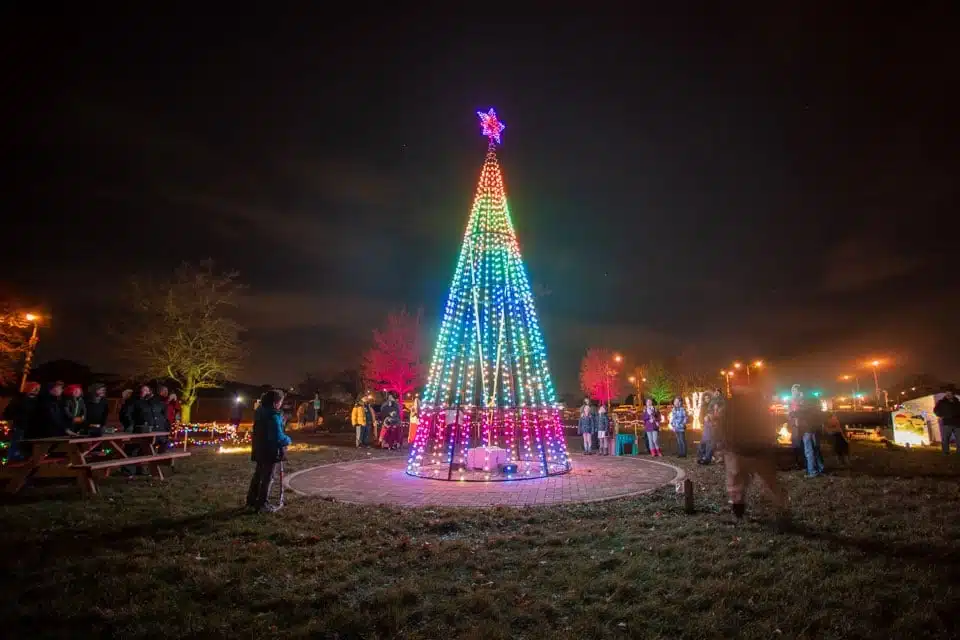 Peoople flocking around the Christmas tree for its tree lighting at the Garden District in Milwaukee 